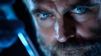 Close up portrait of mature bearded man with intense blue eyes in dramatic dark lighting with blue glow highlighting facial features and creating mysterious atmosphere.