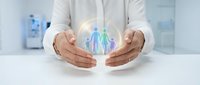 Professional hands protecting glowing family figures symbolizing healthcare insurance coverage and family protection services in modern office.