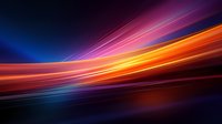 Vibrant light trails create dynamic motion effect with orange, pink and blue streaks against dark background, abstract modern design for technology and speed concepts.