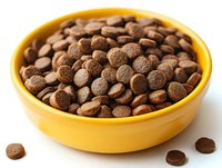 Milk chocolate baking chips in bright yellow ceramic bowl against white background, close-up view showing texture and rich brown color. Food photography for cooking blogs.