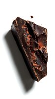 Broken dark chocolate chunk with cocoa nibs exposed, isolated on white background. Suitable for food photography, confectionery design, baking blogs, and culinary marketing materials.