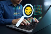 Asian businessman typing on laptop with glowing smiley face emoji and customer satisfaction rating interface for digital marketing and service quality.