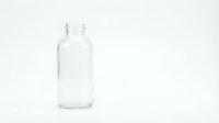 Empty clear glass bottle with metal cap on white background, suitable for product mockups, packaging design, and beverage branding projects.