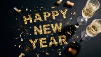 Golden glitter Happy New Year text with champagne glasses and confetti on dark background, festive celebration concept.