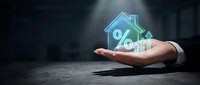 Businessman hand presenting glowing house with percentage symbol for mortgage rates, real estate investment and home loan concepts.
