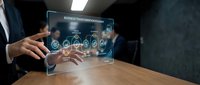 Professional businessman using futuristic holographic interface displaying business transformation icons and digital analytics data on transparent screen.