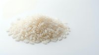 Pile of uncooked white short grain rice isolated on white background, ready for food packaging, cooking websites, and culinary design projects.