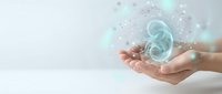 Hands holding glowing kidney organ with digital particles and light effects on clean background for medical healthcare technology concepts.
