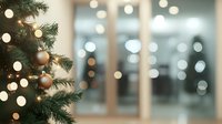 Decorated Christmas tree with rose gold ornaments and soft lights against blurred window background creating festive holiday atmosphere.