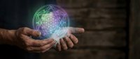 Aged male hands holding a glowing sacred geometry symbol with colorful light, spiritual energy concept on dark wooden background.