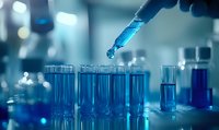 Scientist in laboratory conducting chemical experiment with blue liquid in test tubes and pipette, research and development in medical or pharmaceutical testing environment.