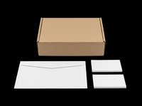 Cardboard shipping box with white envelope and blank cards isolated on transparent background, ready for packaging design, branding mockups, print on demand, and stationery templates.