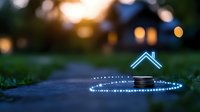 Glowing neon house symbol floating above coins on dark path with magical light trail and bokeh background creates dreamy real estate concept.