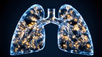 Glowing translucent human lungs with luminous golden light patterns on black background, medical science visualization showing respiratory system anatomy.