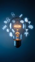 Glowing light bulb surrounded by medical icons including brain, heart, DNA, stethoscope and caduceus on dark blue background.