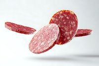 Sliced salami sausage floating in air on white background, fresh deli meat cuts showing texture and marbling pattern. Isolated food photography for menu design.