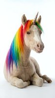 Adorable unicorn foal with vibrant rainbow mane and spiral horn sitting on white background. Fantasy creature for children's products and magical themes.