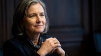 Thoughtful mature Caucasian businesswoman with gray hair in contemplative pose, hands clasped, professional portrait for corporate and leadership concepts.