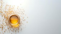 Golden honey in glass jar on white background with scattered bubbles creating artistic composition, minimalist food photography for packaging design and advertising.