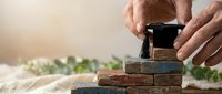 Hands placing wooden blocks with rubber stamp on top, business strategy and planning concept for corporate growth and development.