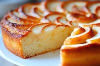 Fresh baked pear upside down cake with caramelized fruit arranged in spiral pattern, close up view showing moist texture and golden brown surface.
