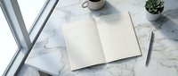 Open blank notebook on marble desk with coffee cup and succulent plant creating minimalist workspace for writing and planning.