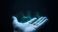 Open palm holding glowing blue digital particles and light effects against dark background for technology and innovation concepts.