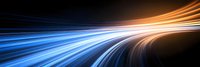 Dynamic light trails streak across dark background creating futuristic motion effect in blue and orange colors, abstract technology concept for modern design backgrounds.
