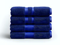 Stack of folded navy blue cotton bath towels with decorative border stripe on white background, isolated for easy integration into design projects.