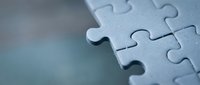 Close-up of interlocking jigsaw puzzle pieces in soft blue tones, symbolizing teamwork, problem-solving, and business solutions with copy space.