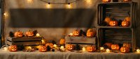 Rustic Halloween display with carved pumpkins arranged on wooden crates and shelves, illuminated by warm string lights for seasonal home decor and party setup.