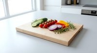 Fresh vegetables arranged on wooden cutting board in modern kitchen for healthy cooking and meal preparation.