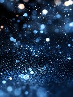 Magical blue glitter sparkles on dark background with bokeh effect and defocused light particles creating dreamy atmospheric composition.