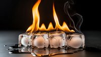 Fire and ice concept with burning ice cubes creating dramatic flames and steam against dark background for creative design projects.