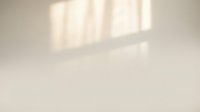 Soft natural window light casting geometric shadows on minimalist beige wall creating warm ambient atmosphere for interior design and architecture projects.