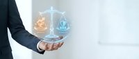 Businessman in dark suit holding glowing scales of justice with fire and water elements, symbolizing balance, law, ethics, and decision-making for legal and business concepts.