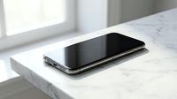 Modern black smartphone with sleek design lying on white marble surface near bright window. Contemporary mobile device technology for communication and digital lifestyle.