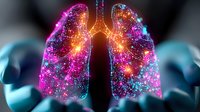 Glowing multicolored human lungs with sparkle effect on black background, anatomical visualization showing respiratory system in vibrant pink and blue colors.