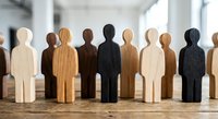 Wooden human figures in various colors representing diversity and teamwork concepts for business presentations and corporate training materials.