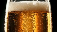 Chilled cola or dark soda beverage with condensation and carbonation bubbles in glass, suitable for beverage advertising and refreshment marketing.
