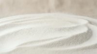 Close-up of smooth sand waves with soft, rippled texture creating natural patterns and shadows for spa, wellness, and zen meditation backgrounds.
