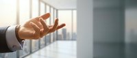 Businessman in formal attire reaching out hand in modern office space, symbolizing connection, agreement, or welcoming gesture for corporate communication needs.