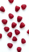 Fresh red raspberries arranged on white background, isolated and ready for food, nutrition, healthy eating, and culinary design projects.