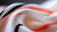 Abstract flowing fabric waves in white with red and black accents creating dynamic motion blur effect for modern design projects.