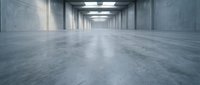 Modern concrete warehouse interior with polished floors and fluorescent lighting for industrial and commercial design projects.