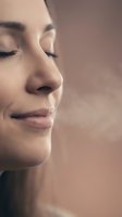 Serene young woman with closed eyes in peaceful meditation pose showing natural skin texture and calm facial expression for wellness and mindfulness concepts.