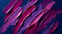 Vibrant magenta and purple paint strokes with metallic sheen on deep blue background, suitable for modern design, cosmetics, and creative projects.