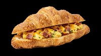 Croissant sandwich filled with scrambled eggs and bacon on transparent background, ready for menu design, restaurant graphics, food packaging, print-on-demand products, and culinary marketing materials.