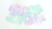 Soft watercolor wash in pastel purple and mint green tones creating organic flowing shapes on textured paper background for artistic projects.
