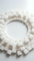 White sugar cubes arranged in a circular frame on isolated background, suitable for food photography, nutrition concepts, sweetener advertising, and culinary design projects.